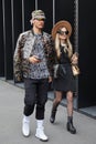 Man with transparent jacket and woman with black coat before Gucci fashion show, Milan Fashion