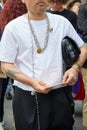 Man with white shirt, black trousers and silver chain necklace before Fendi fashion show, Milan