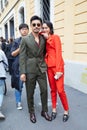 Man and woman with green and orange suit before Boss fashion show, Milan Fashion Week street
