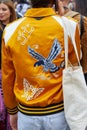 Man with yellow satin bomber jacket with eagle design before Fila fashion show, Milan Fashion