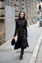 Mary Leest with black embroidered dress and bag walking before Ermanno Scervino fashion show,