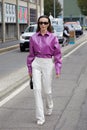 Mary Leest with purple, shiny plastic shirt and white trousers before MSGM fashion show, Milan