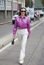 Mary Leest with purple, shiny plastic shirt and white trousers before MSGM fashion show, Milan