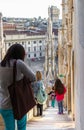 Numerous tourists descend the stairs from the roof of the Cathedral of Milan - Duomo di Milano in Milan city, Italy