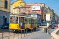 Milan, Italy, old yellow traditional tram on street in summer day