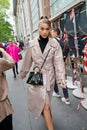 Woman with beige trench coat before Fendi fashion show, Milan Fashion Week street style