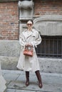 Woman with beige trench coat and sunglasses before Max Mara fashion show, Milan Fashion Week