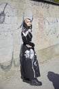 Woman with black dress with floral design before Valentino fashion show, Milan Fashion Week