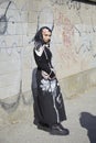 Woman with black dress with floral design before Valentino fashion show, Milan Fashion Week