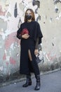 Woman with black dress and red leather bag before Valentino fashion show, Milan Fashion Week