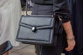 Woman with black leather Serpenti bag before Tiziano Guardini fashion show, Milan Fashion Week