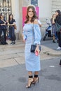 Woman with blue dress and black high heel shoes before Genny fashion show, Milan Fashion Week