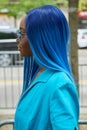 Woman with blue hair and jacket before Fendi fashion show, Milan Fashion Week street style