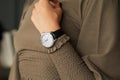 Woman with Carl Bucherer luxury watch and brown dress before Peter Pilotto fashion show, Milan