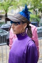 Woman with Fendi cap, purple dress and blue hair before Fendi fashion show, Milan Fashion Week