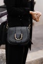 Milan, Italy - September, 25: woman influencer wearing black messenger handbag from Elisabetta Franchi. Fashion blogger