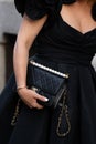 Milan, Italy - September, 25: woman influencer wearing black shoulder bag from Chanel. Fashion blogger outfit details