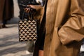 Milan, Italy - September, 23: woman influencer wearing micro Symbole jacquard tote bag from Prada. Fashion blogger