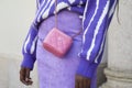 Woman with pink leather Chanel bag and purple skirt before Ports 1961 fashion show, Milan