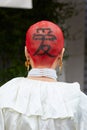 Woman with red hair and black ideogram on head before Fila fashion show, Milan Fashion Week