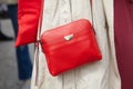 Woman with red leather Coccinelle bag before Tiziano Guardini fashion show, Milan Fashion Week