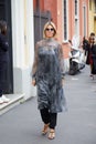 Woman with silver transparent dress and black trousers before Boss fashion show, Milan Fashion