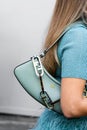 Milan, Italy - September, 21, 2022: woman wearing mint green matte leather pouch handbag from Fendi, street style outfit