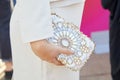 Woman with white dress and bag with gold and white gems decoration before Luisa Beccaria Royalty Free Stock Photo