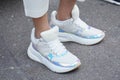 Woman with white and iridescent sneakers before Luisa Beccaria fashion show, Milan Fashion Week