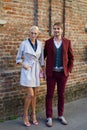 Woman with white jacket and man with burgundy suit before Salvatore Ferragamo fashion show,