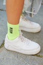 Woman with white Nike sneakers and yellow Msgm socks before Msgm fashion show, Milan Fashion