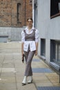 Woman with white shirt and checkered trousers before Max Mara fashion show, Milan Fashion Week