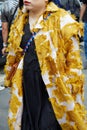 Woman with white and yellow coat with roses design before Fila fashion show, Milan Fashion Week