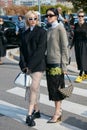 Women with black jacket and gray sweater before Prada fashion show, Milan Fashion Week street