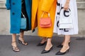Women with blue, orange coat and white dress before Prada fashion show, Milan Fashion Week
