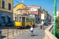 Milan, Italy, old yellow traditional tram on street in summer day