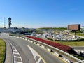 MIlan, Italy, 19.04.2022. View of parking area and control tower at Malpensa airport. Royalty Free Stock Photo