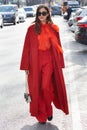 Eleonora Carisi poses for photographers with orange coat and trousers before Emporio Armani fashion show on