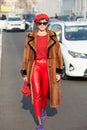 Eleonora Carisi with red trousers and brown fur coat before Dsquared 2 fashion show, Milan Fashion Week street