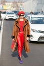 Eleonora Carisi with red trousers and brown fur coat before Dsquared 2 fashion show, Milan Fashion Week street