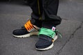 Man with black Nike shoes with orange and green shoelaces before Represent fashion show, Milan Fashion Week