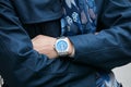 Man with Breitling watch with blue dial and blue coat before Giorgio Armani fashion show, Milan Fashion Week