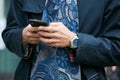 Man with Breitling watch typing on smartphone before Giorgio Armani fashion show, Milan Fashion Week street Royalty Free Stock Photo