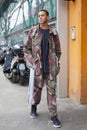 Man with green, gray and dark red camouflage jacket and trousers before Giorgio Armani fashion show, Milan Royalty Free Stock Photo