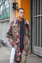 Man with green, gray and dark red camouflage jacket and trousers before Giorgio Armani fashion show, Milan Royalty Free Stock Photo