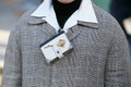 Man with small book with golden rose necklace before Emporio Armani fashion show, Milan Fashion Week street