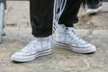 Man with white JW Anderson Converse shoes and black Adidas trousers before Fendi fashion show, Milan Fashion