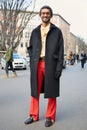 Stylish man with red trousers and Gucci belt poses for photographers before Giorgio Armani fashion show on