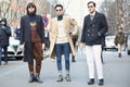 Three stylish men poses for photographers before Giorgio Armani fashion show on January 19, 2015 in Milan,