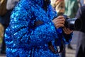 Woman with Canon professional camera and blue sequin coat before MSGM fashion show, Milan Fashion Week street